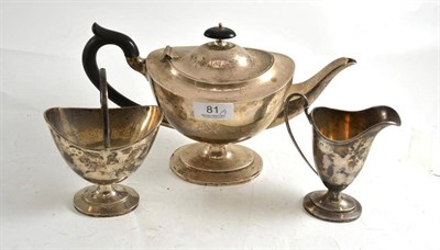 Lot 81 - A silver Neo-Classical style three piece tea set comprising teapot, cream helmet and swing...