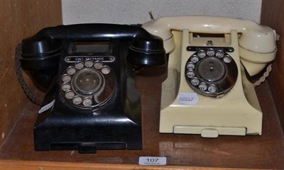 Lot 107 - Cream Bakelite vintage telephone and another in black (2)