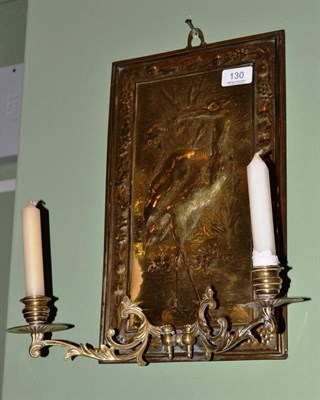 Lot 130 - An Arts & Crafts brass wall sconce, embossed with a heron