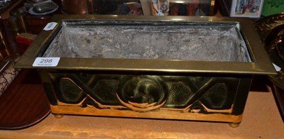 Lot 298 - An Arts & Crafts embossed brass planter with zinc liner