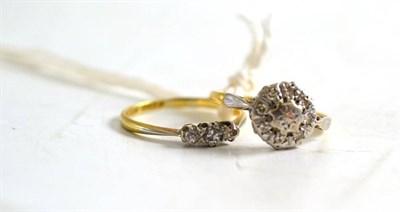 Lot 322 - A diamond three stone ring and a diamond cluster ring (2)