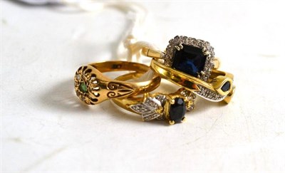 Lot 323 - A sapphire and diamond cluster ring and three other dress rings (4)