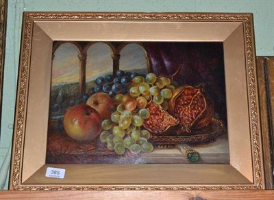 Lot 385 - 19th century, Still life of a plate of grapes, apples and a pomegranate with classical landscape in