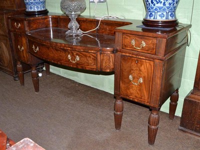 Lot 410 - A large 19th century mahogany sideboard with bow front and reeded legs