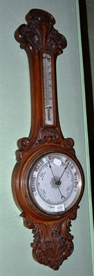 Lot 428 - Victorian aneroid barometer with carved frame and thermometer