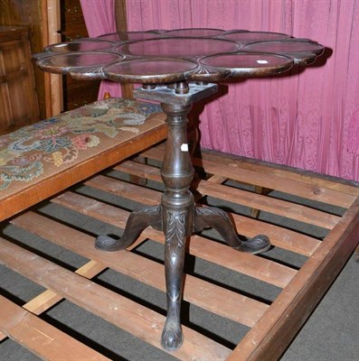 Lot 447 - A carved mahogany tripod table