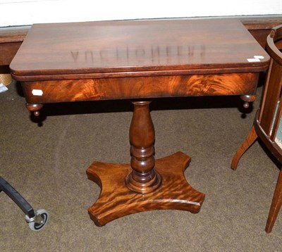 Lot 492 - George IV mahogany fold-over card table on a turned baluster column on shaped foot