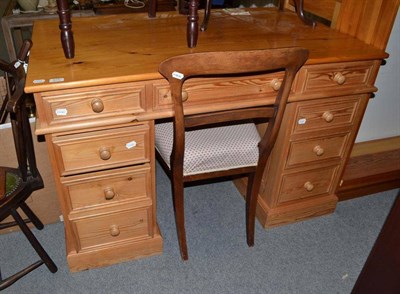 Lot 575 - A modern pine desk and a pine bookcase