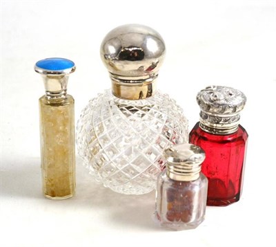 Lot 21 - Silver lidded and cut glass scent bottle and three others