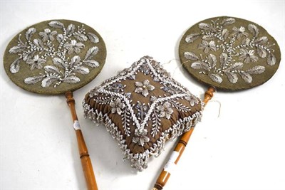 Lot 57 - A pair of Victorian beadwork face screens on turned wooden handles and a beadwork pin cushion (3)