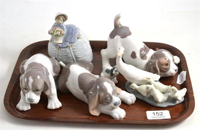 Lot 152 - Four Lladro puppies, a goose group and a lady holding flowers (6)