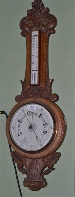 Lot 188 - An aneroid barometer (a.f.) in carved oak case