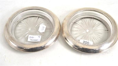 Lot 200 - Pair of American silver mounted glass wine coasters