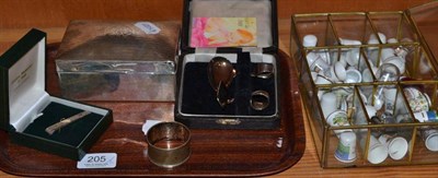 Lot 205 - A silver cigarette box, a napkin ring, a tie pin, a spoon and pusher and a quantity of thimbles