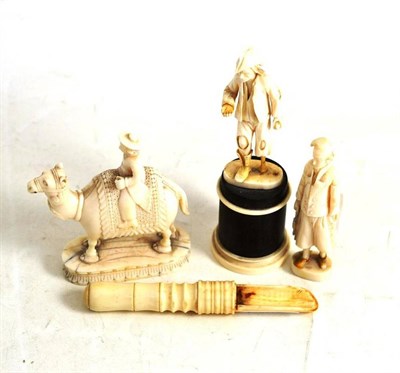 Lot 214 - Two ivory Napoleonic figures, an unusual ivory figure of a Dutch trader on a camel and an apple...