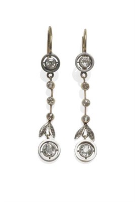 Lot 353 - A Pair of Diamond Drop Earrings, an old cut diamond in a white fronted disk frame suspends a row of