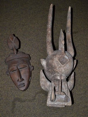 Lot 244 - A Senufo, Ivory Coast Kponyugu (Chaos of the Universe) light wood mask, with powerful jaws,...