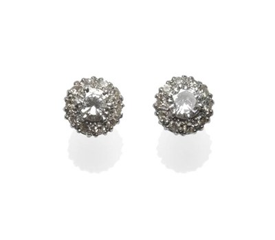 Lot 355 - A Pair of Diamond Cluster Stud Earrings, each with a round brilliant cut diamond centrally within a