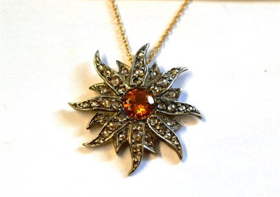 Lot 356 - A Starburst Pendant on Chain, the pendant with a round brilliant cut citrine centrally, within...