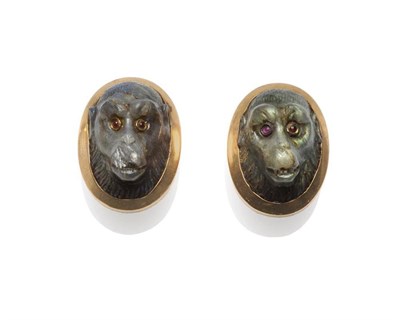 Lot 367 - Two Ape Buttons, carved from a dark coloured opalescent stone and inset with ruby eyes, within...