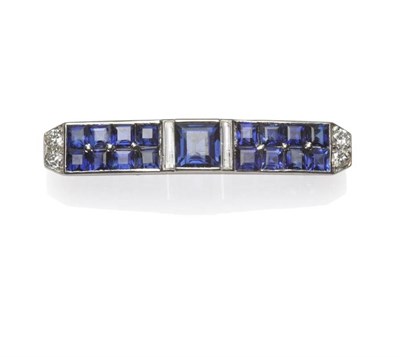 Lot 371 - A Sapphire and Diamond Brooch, signed 'CARTIER', the curved brooch comprising a square step cut...