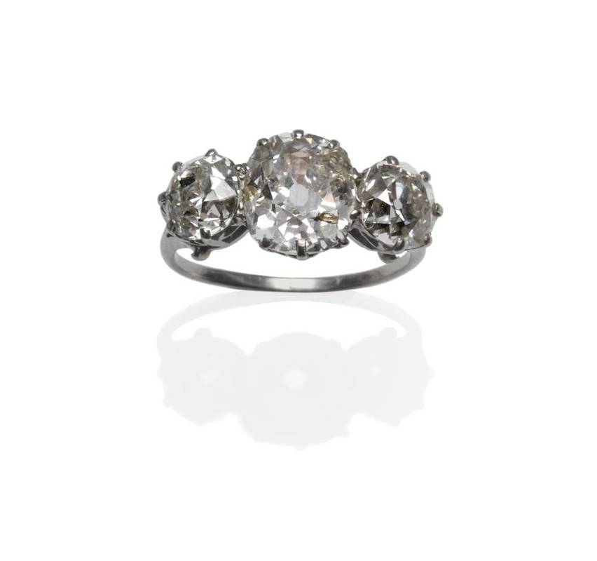 Lot 372 - An Early 20th Century Diamond Three Stone Ring, a central old mine cut diamond flanked by an...