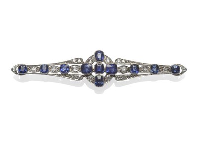 Lot 380 - A Sapphire and Diamond Bar Brooch, circa 1925, the long bar with a central cluster to tapering...