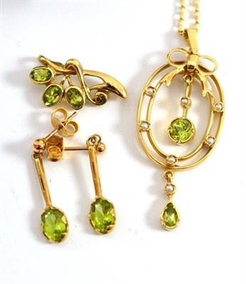 Lot 24 - A peridot and seed pearl pendant on chain, a pair of peridot earrings and a peridot pendant