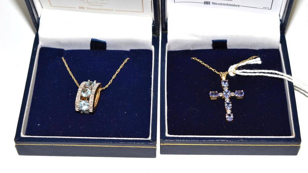 Lot 56 - A diamond and blue topaz pendant and a diamond and tanzanite cross on chain
