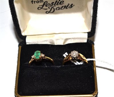 Lot 61 - An 18ct gold diamond solitaire ring and a 9ct gold emerald and diamond ring (2)