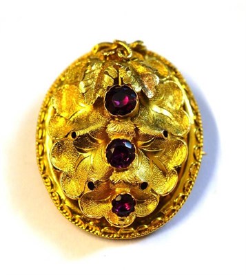 Lot 393 - A Victorian Brooch, the oval form with textured stylised leaf motifs, three purplish-pink...