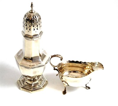 Lot 128 - A silver sugar caster retailed by Harrods and a cream jug