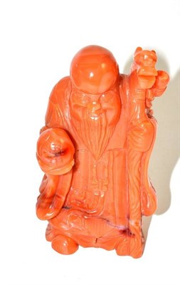 Lot 145 - An orange coloured agate figure of Shou Lao (a.f.)