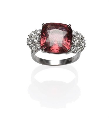 Lot 400 - An 18 Carat White Gold Garnet and Diamond Ring, the cushion shaped garnet with a semi circle...