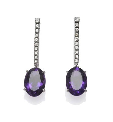 Lot 401 - A Pair of 18 Carat White Gold Amethyst and Diamond Drop Earrings, a row of round brilliant cut...