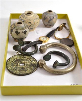 Lot 182 - Three 18th century Vietnamese ointment jars, three Nigerian manillas, a Chinese coin, two...