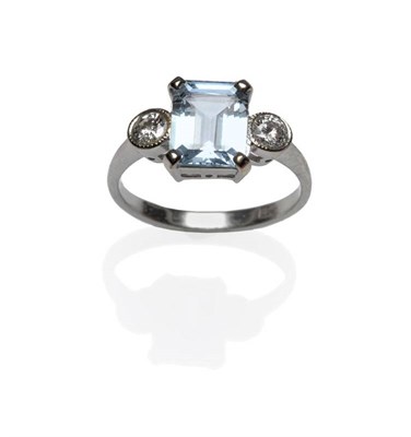 Lot 402 - An Aquamarine and Diamond Three Stone Ring, the emerald-cut aquamarine in a white four claw...