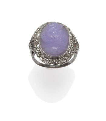 Lot 410 - A Lilac Jade and Diamond Ring, the oval carved and polished jade depicting a dragon in a...