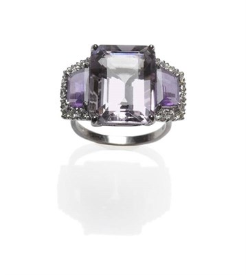 Lot 411 - An 18 Carat White Gold Amethyst and Diamond Ring, a pale purple amethyst centrally with a trapezium