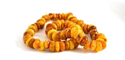 Lot 305 - An amber bead necklace of brown to orangey-yellow disk shaped beads