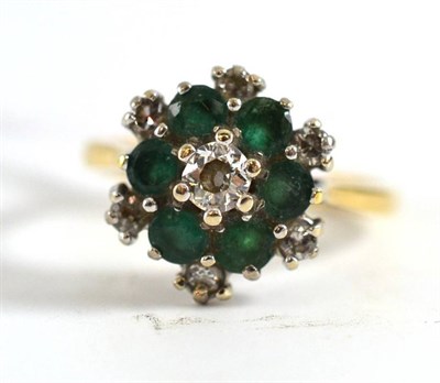 Lot 320 - An 18ct gold diamond and emerald cluster ring, total estimated diamond weight 0.35 carat...