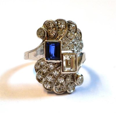 Lot 417 - A Sapphire and Diamond Ring, a baguette cut sapphire and a baguette cut diamond in white rubbed...