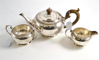 Lot 385 - A silver three piece tea service, Goldsmiths, London, in original box