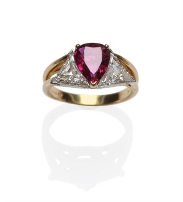 Lot 422 - A Ruby and Diamond Three Stone Ring, by Oscar Heyman & Brothers, the pear cut ruby flanked by a...