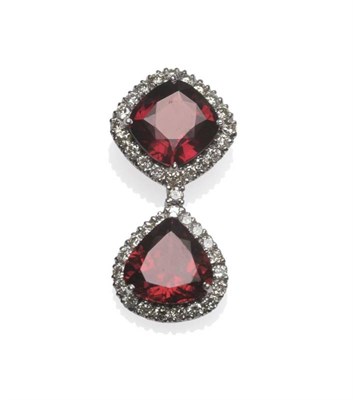 Lot 425 - An 18 Carat White Gold Garnet and Diamond Pendant, a cushion cut garnet within a border of...