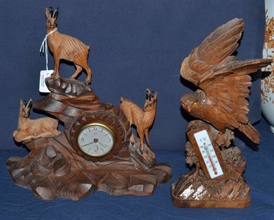 Lot 423 - A carved desk/mantel timepiece and a carved thermometer desk piece, inscribed base (2)