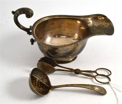 Lot 456 - Silver sauce boat, silver tongs and silver spoon