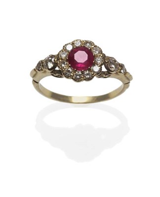 Lot 430 - A Ruby and Diamond Ring, a round mixed cut ruby within a border of round brilliant cut...