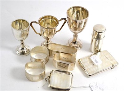 Lot 475 - Four silver napkin rings, silver vesta, silver card case, three silver trophy cups and a silver...