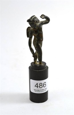 Lot 486 - Probably Roman, a bronze figure of Cupid on a turned slate base, 14cm high